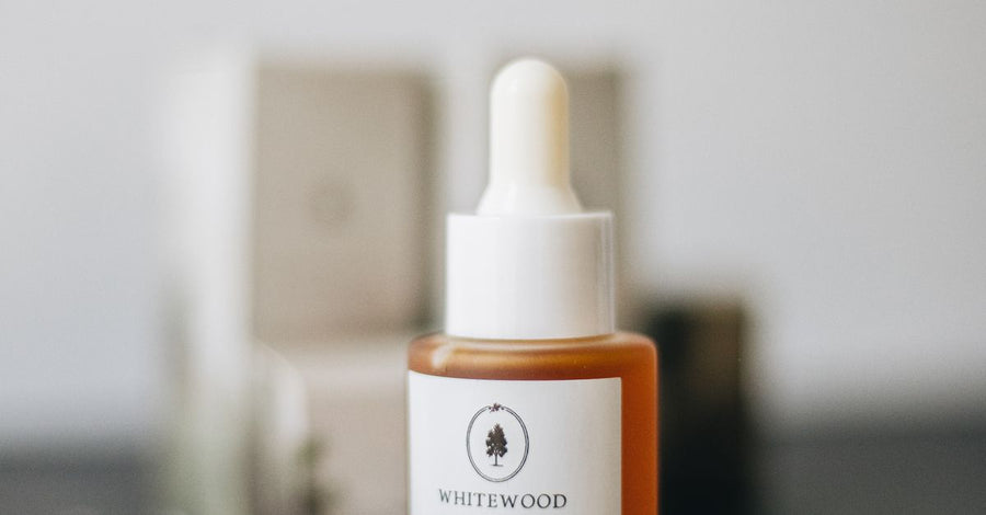 Minimalist skincare serum bottle on a dark surface